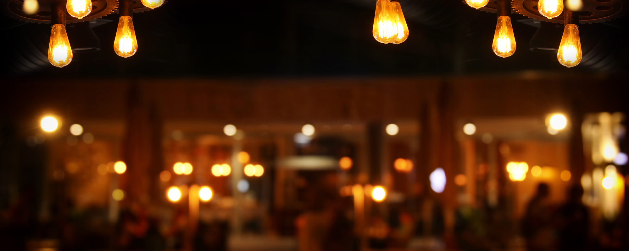 Image Of Wooden Table In Front Of Abstract Blurred Restaurant Lights Background.